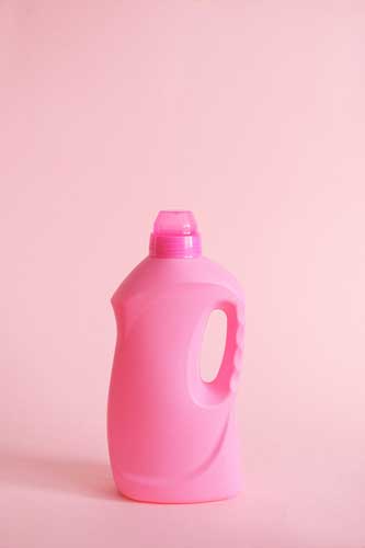 pink laundry bottle on pink background